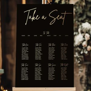 black and gold take a seat wedding sign